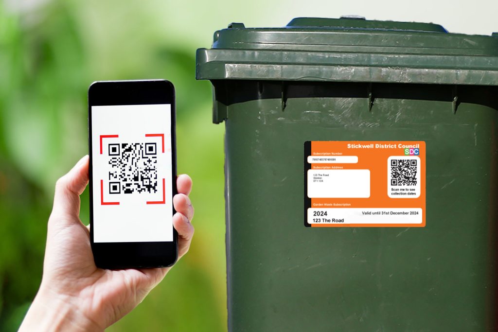 Close up of a hand holding smartphone and scanning the qr code to make a payment, in Portuguese. Cashless technology concept